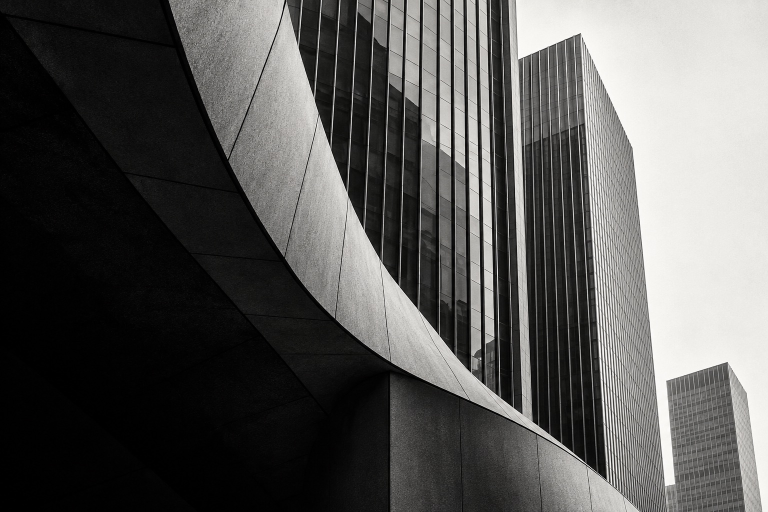Black-and-white architectural illustration of curved and vertical financial-district facades.